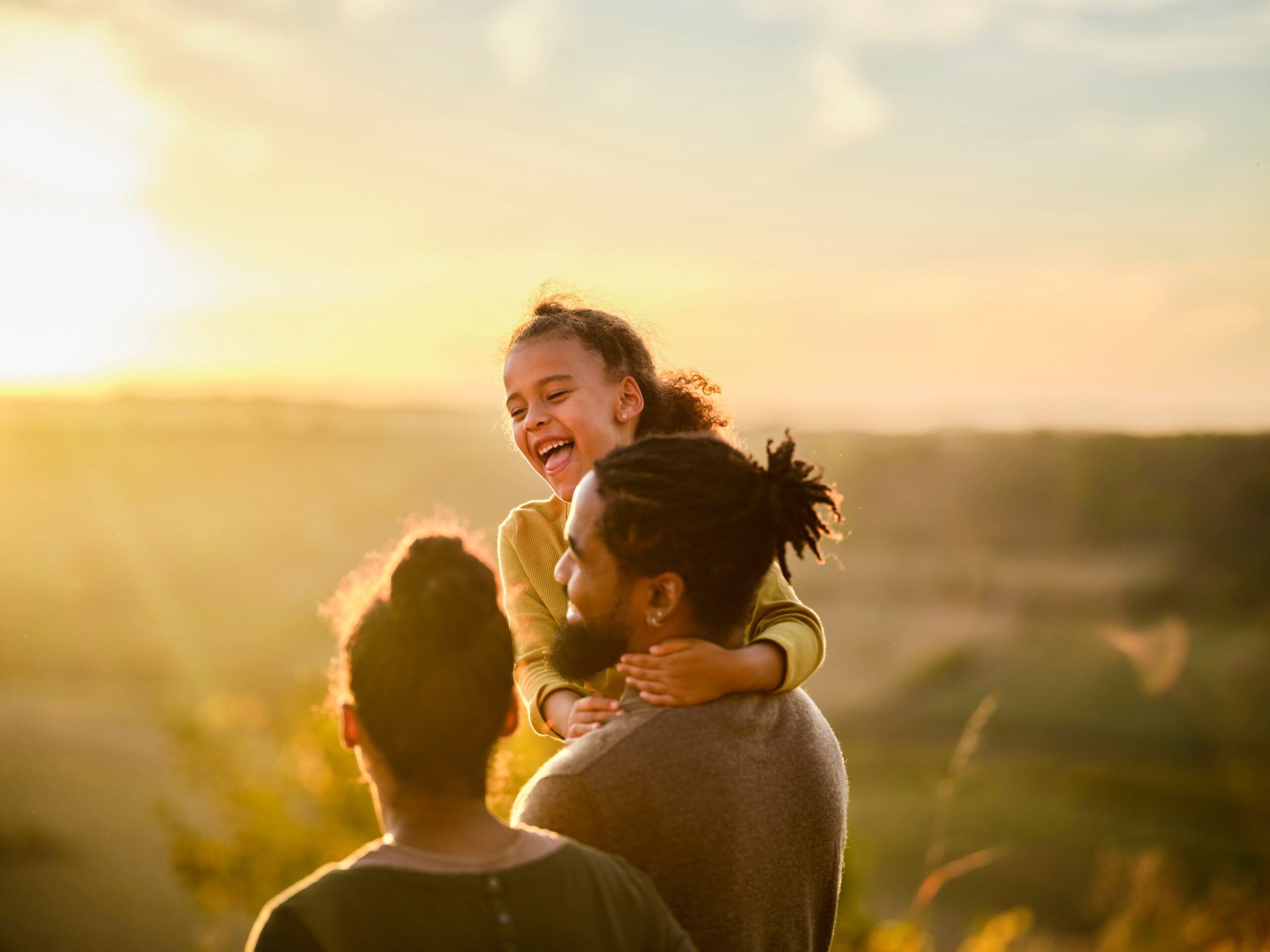 Family enjoying a sunset over rolling hills near Humber Station in Bolton, Caledon